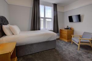 a hotel room with a bed and a desk and a tv at Best Western Stoke on Trent City Centre Hotel in Stoke on Trent
