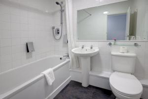 a white bathroom with a toilet and a sink at Best Western Stoke on Trent City Centre Hotel in Stoke on Trent