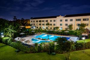 an image of a hotel with a pool at night at Fiesta Royale Hotel in Accra