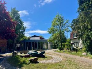 a house with a sculpture on the side of a road at Feldberg4you DesignZimmer in Feldberg
