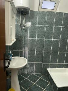 a bathroom with a sink and a toilet at Villa Pistula apartments in Ulcinj
