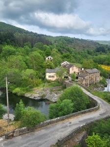 a view of a town with a river and houses at Auberge du Tarnon in Vébron