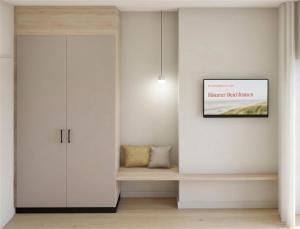a living room with a cabinet and a picture on the wall at Gezeiten Suites Büsumer Deichhausen - Neueröffnung in Büsumer Deichhausen