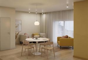 a dining room and living room with a table and chairs at Gezeiten Suites Büsumer Deichhausen - Neueröffnung in Büsumer Deichhausen