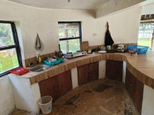 a kitchen with a counter top and a sink at Tiny house, kitchen downstairs in Shimoni