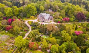 an aerial view of a large house in a forest at The Clock House in Harford +19 photos