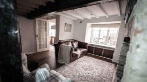 a living room with a couch and a window at Freya's Cottage in Lincoln