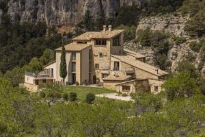a large house on top of a mountain at Hotel Mas de la Serra in Fuentespalda
