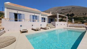 a villa with a swimming pool and a house at Doto Villa with private pool in Agia Effimia