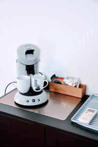 a coffee maker with two cups on a counter at Dormir près de Brioude - studio 'esprit cocon' in Fontannes