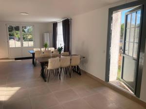 a dining room with a table and some chairs at Barbe Bleue 1982 in Bridoré +18 photos
