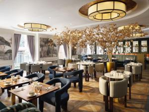 a restaurant with tables and chairs and lights at The Davenport in Dublin +22 photos