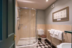 a bathroom with a shower and a toilet and a sink at The Dundas Arms in Kintbury +56 photos