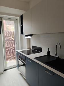 a kitchen with a sink and a counter top at The Dome in Orbetello