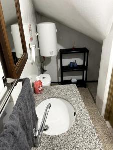 a bathroom with a white sink and a mirror at Flat with nice view in Gualtar, Braga in Braga
