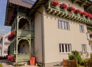 a house with flowers on the balconies at Apartments Vila Marjetica in Bled