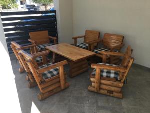 a group of chairs and a wooden table and chairs at Zimmer Katarina in Vodice +20 photos