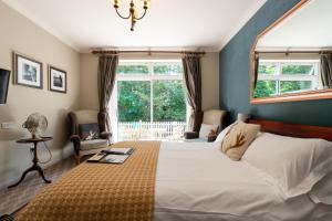 a bedroom with a large bed and a window at The Dundas Arms in Kintbury