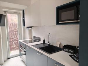 a small kitchen with a sink and a window at The Dome in Orbetello