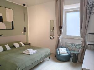 a bedroom with a bed and a mirror and a chair at The Dome in Orbetello