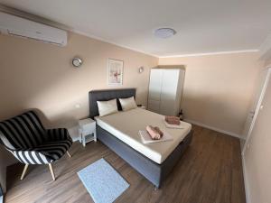a small bedroom with a bed and a chair at Villa Vento Mostar in Mostar +14 photos