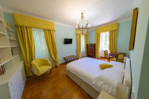 a bedroom with a bed and a chandelier at Villa dei Papi Subiaco in Subiaco +30 photos