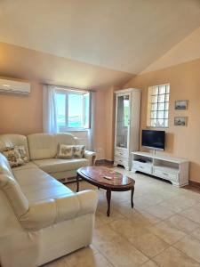 a living room with a couch and a coffee table at Apartments Coral, Klimno, island Krk in Klimno