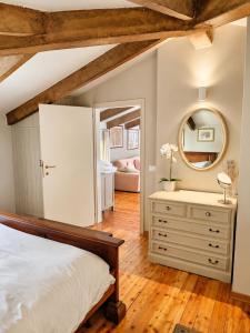 a bedroom with a bed and a mirror and a dresser at Garden Loft by Veneto Villa in Albignasego