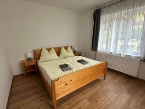 a bedroom with a wooden bed in a room at Ferienapartments 31erHaus in Hieflau