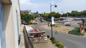 a view of a street with a food stand on a building at Victor Hugo's Le Central in Saint-Junien