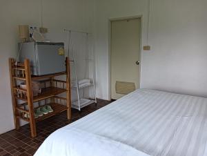 a bedroom with a bed and a tv and a door at Pai sunrise camping resort in Pai