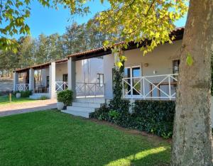 a house with a tree in front of it at Mon Rêve Estate in Cape Town