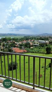 a view of a green field from a balcony at Kigo Perch in Kampala