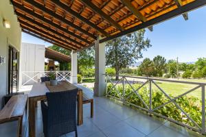 an outdoor patio with a table and chairs and a fence at Mon Rêve Estate in Cape Town
