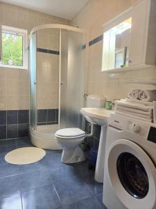a bathroom with a toilet sink and a washing machine at Apartments Coral, Klimno, island Krk in Klimno +40 photos
