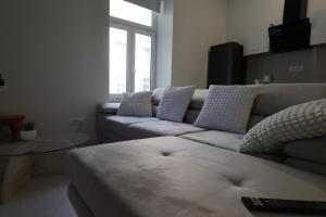 a living room with a couch and a table at Downtown Condo w Huge TV in Zagreb