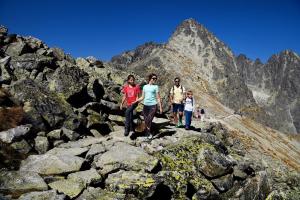 a group of people standing on rocks on a mountain at Grand Hotel Praha in Tatranská Lomnica +91 photos