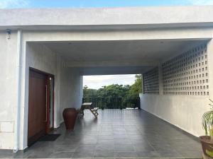 an external view of a white house with a patio at Ponto de Ouro in Lopes