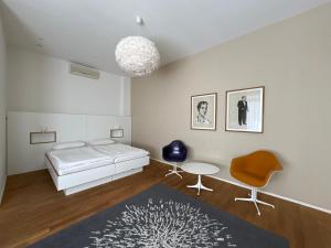 a bedroom with a bed and a table and a chair at ART Hotel Ufer in Düsseldorf