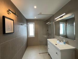a bathroom with a sink and a mirror at Villa Eha in Kuressaare +32 photos