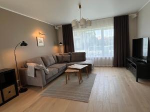 a living room with a couch and a table at Villa Eha in Kuressaare
