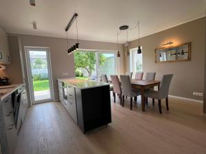 a kitchen and dining room with a table and chairs at Villa Eha in Kuressaare