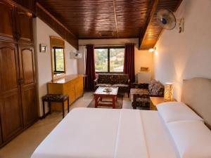 a bedroom with a white bed and a living room at Roc Heights in Bakau +77 photos