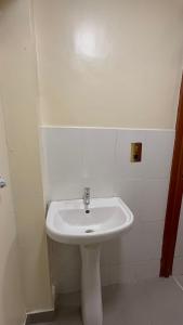 a bathroom with a white sink in a room at Affar homes in Kumasi