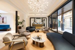 a living room with furniture and a chandelier at Casa Laveni in Milan