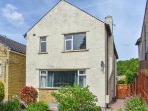 a white brick house with a window at Huddersfield House, Wood View in Huddersfield