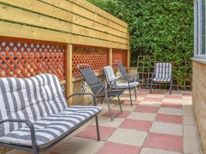 a group of chairs sitting on a patio at Huddersfield House, Wood View in Huddersfield