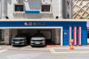 two cars are parked in a car garage at Yeongdeungpo Hotel Jago in Seoul