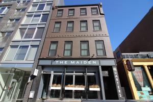 a building with a sign for the malden at West Broadway Quarters by Thatch in Boston