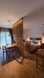 a large bedroom with a bed and a table at PIRA BOUTIQUE hotel in Postojna